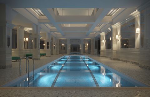 Langer Innenpool in einer großzügigen Halle mit weißen Säulen, Marmorverkleidungen und indirekter Beleuchtung. Das Wasser ist blau beleuchtet und spiegelt die Architektur des Raumes. Lap_Pool_credit_Visualisation_One.jpg